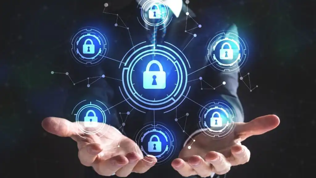 A business professional holding digital padlock icons representing cybersecurity protection and data safety in 2025.