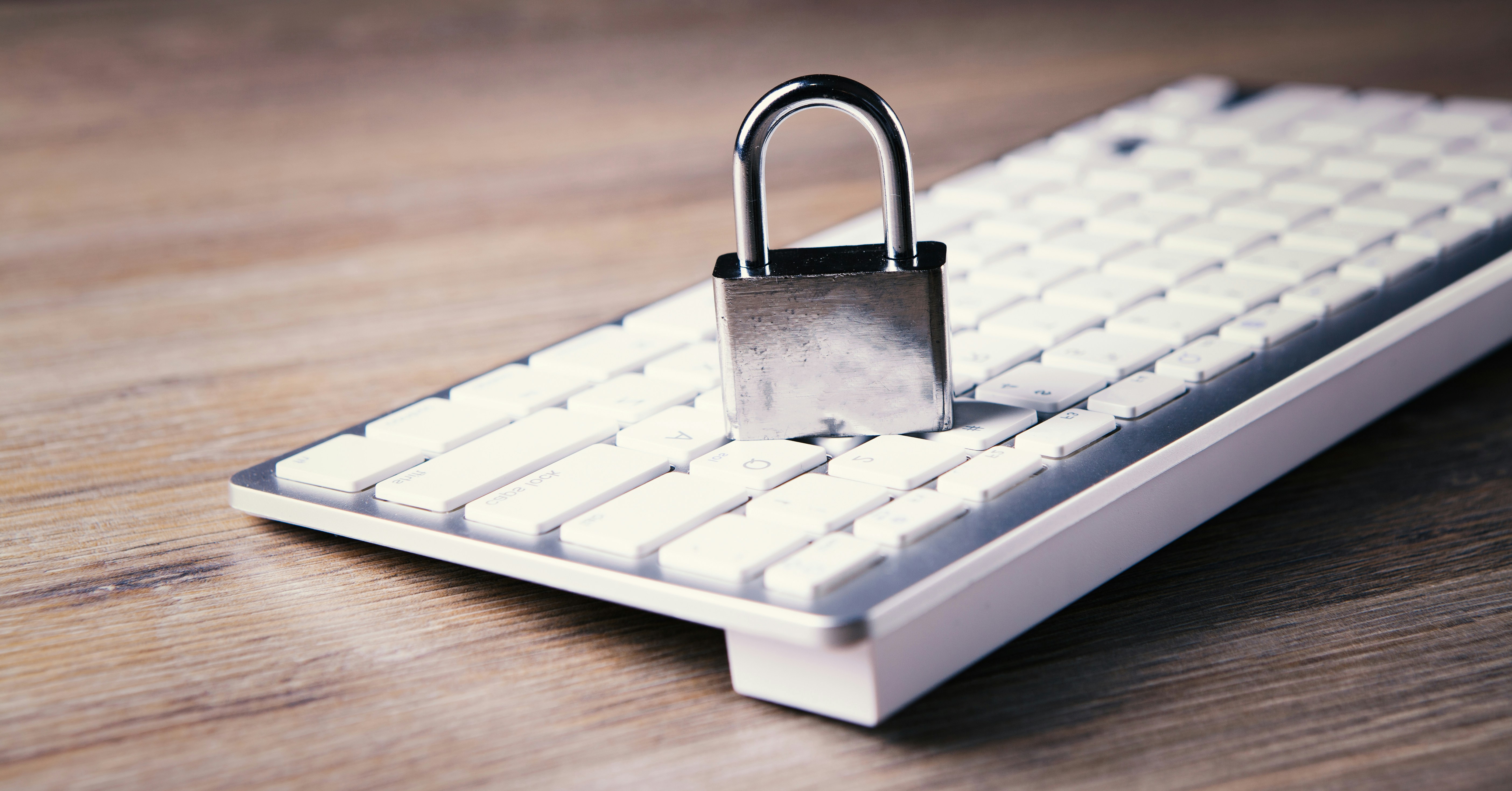 Padlock sitting on a computer keyboard symbolising data protection and privacy compliance for businesses.